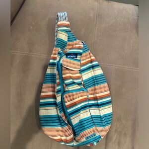 Kavu crossbody bag, teal, orange, tan, and blue.